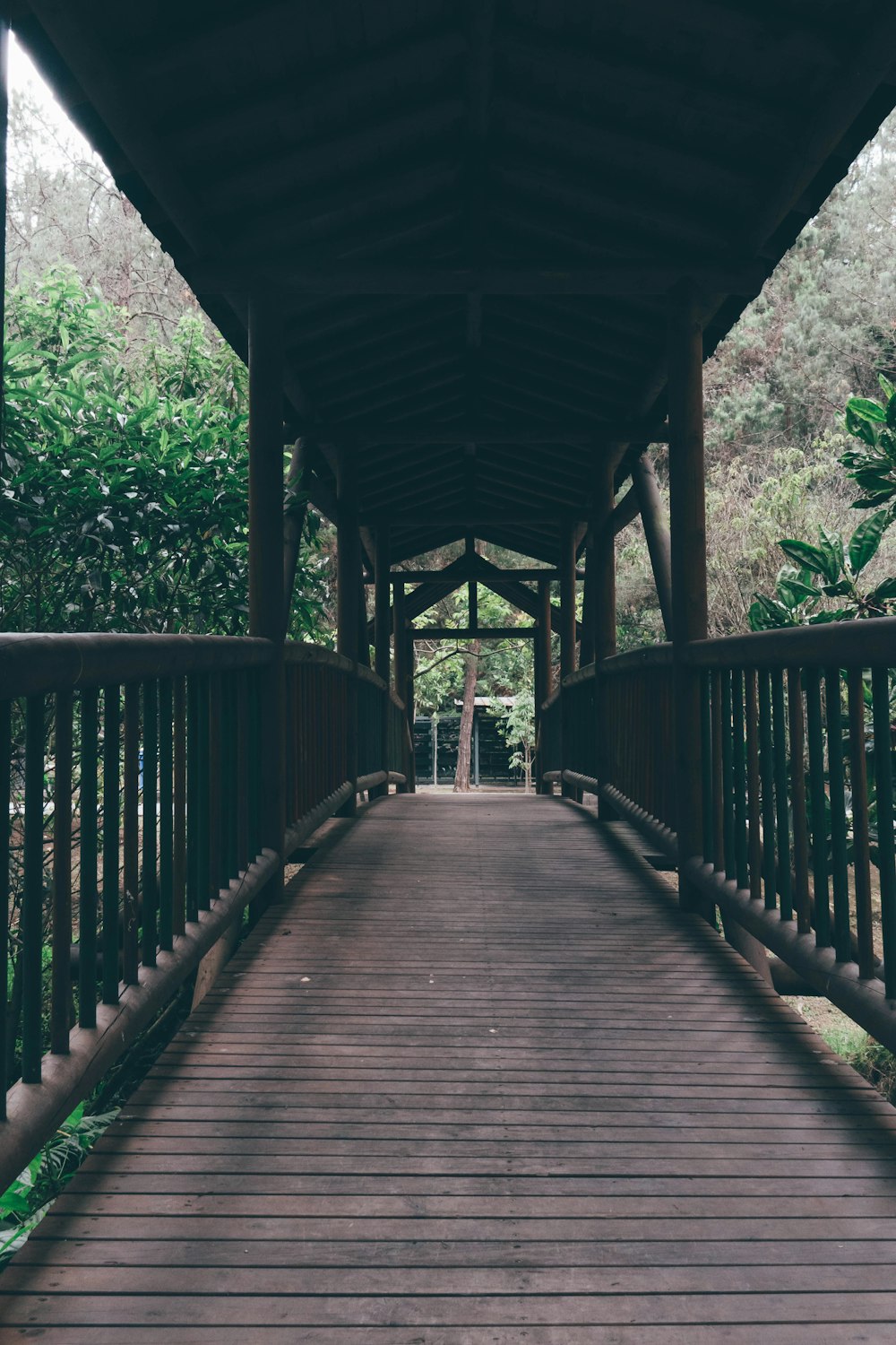 a wooden walkway leading to a covered area