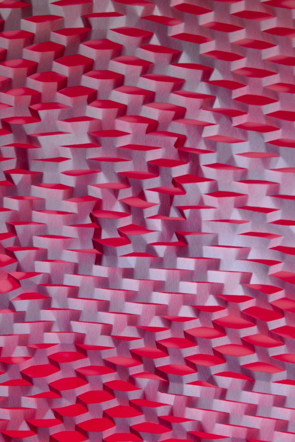 a painting of a red and white pattern on a wall