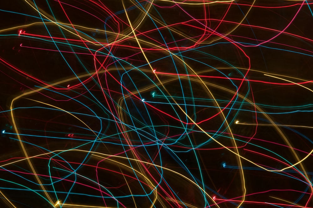 a bunch of colorful lights that are in the dark