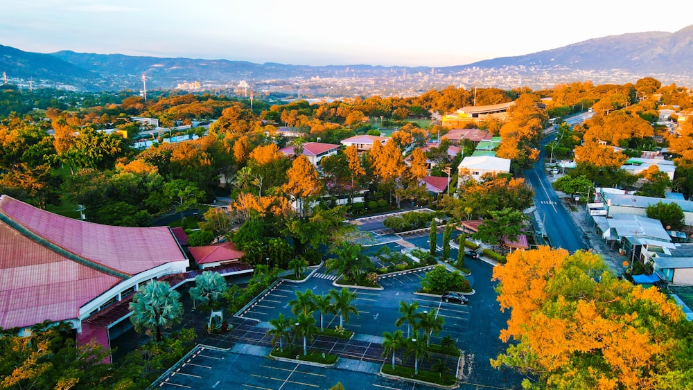 an aerial view of a parking lot surrounded by trees