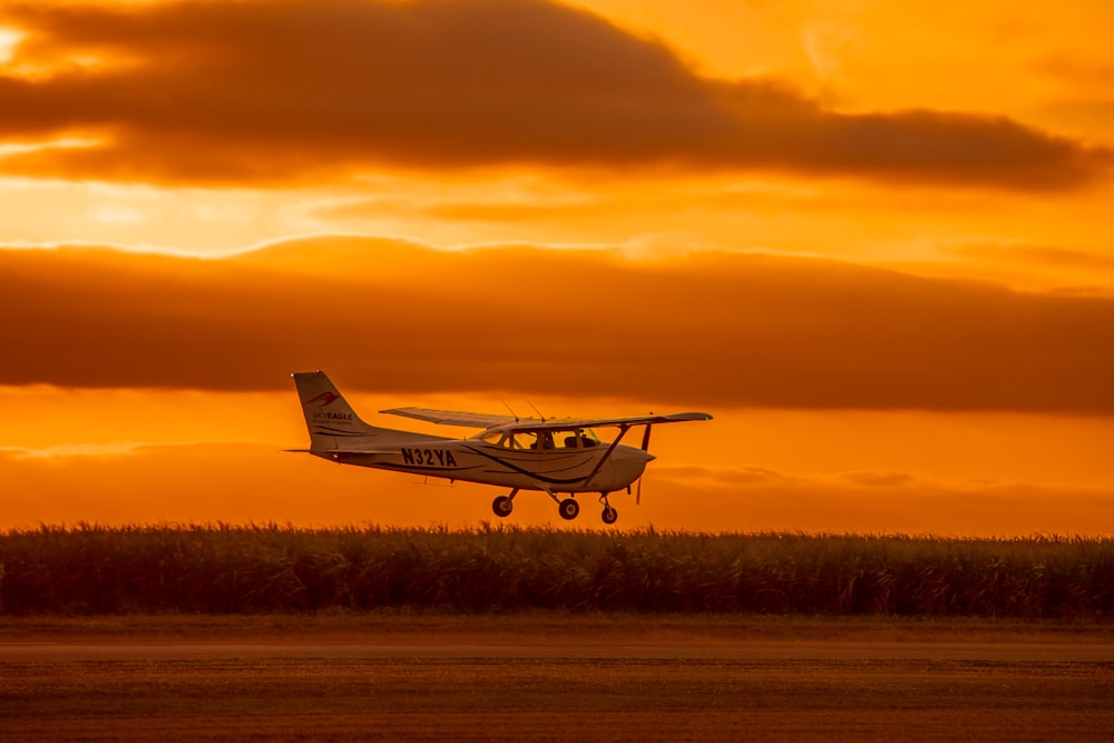 a small plane is flying low to the ground