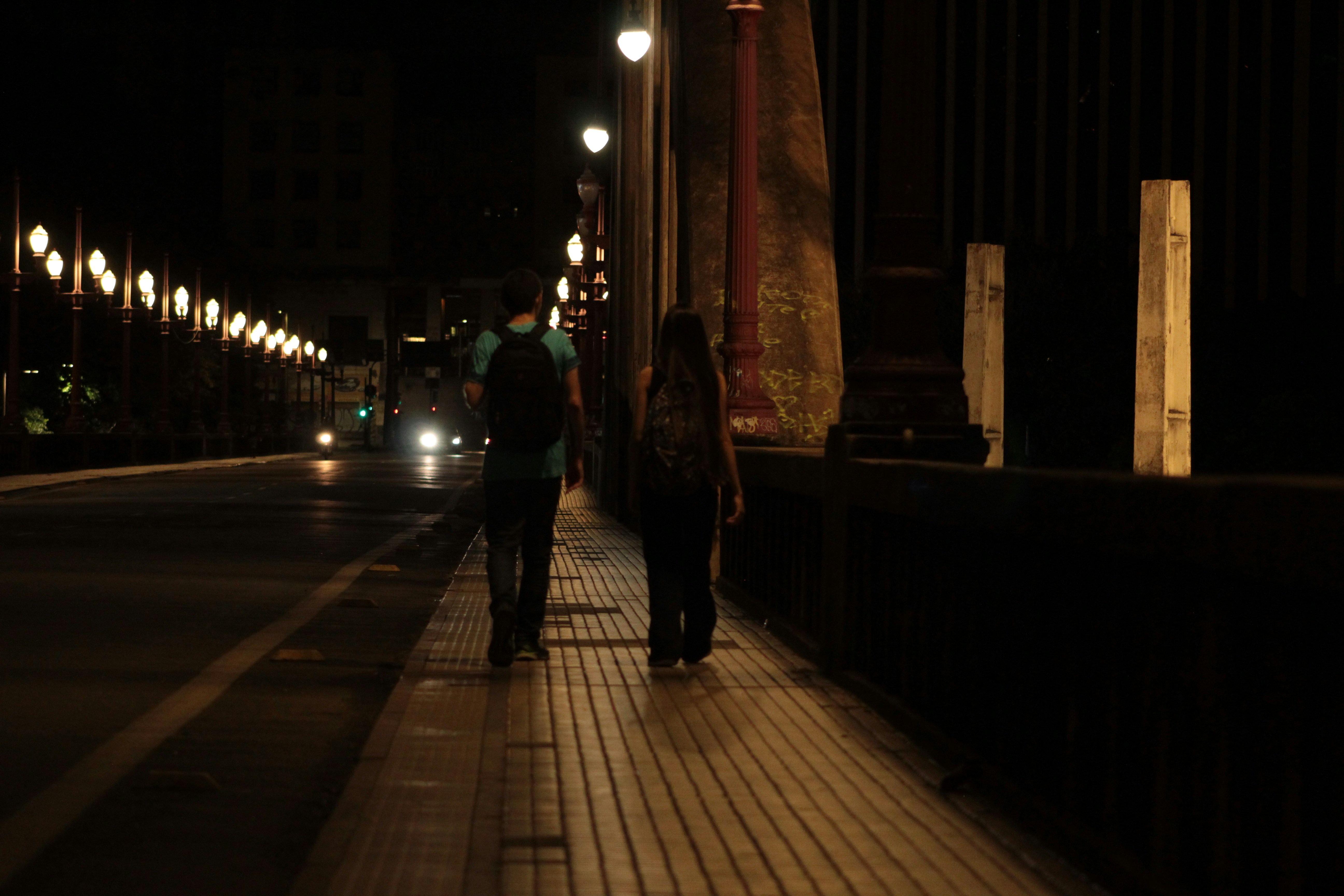 A couple walking down a charming Melbourne CBD laneway at night