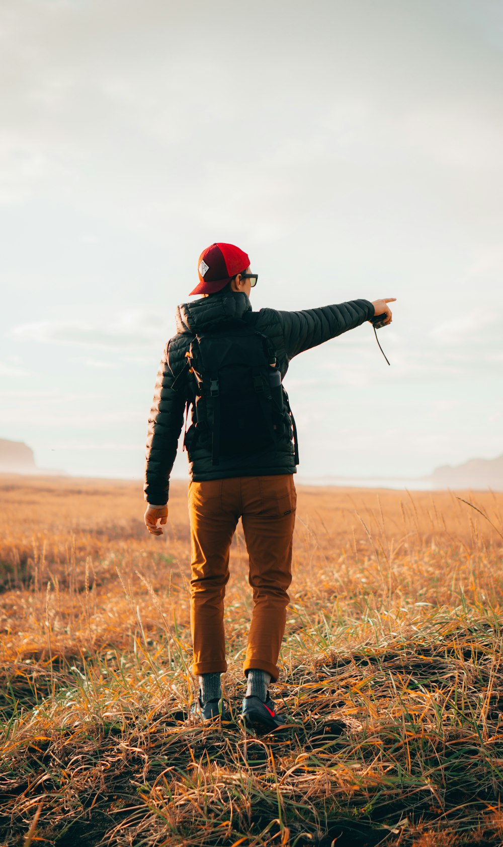 a person standing in a field pointing at something