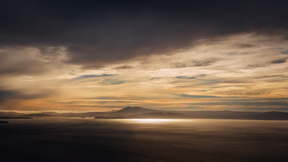 a view of a body of water with mountains in the background