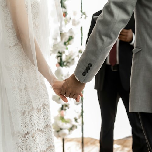 Bride and groom exchanging vows during an outdoor wedding ceremony