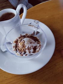 Close-up of a handcrafted chocolate dessert alongside a freshly brewed tea cup.
