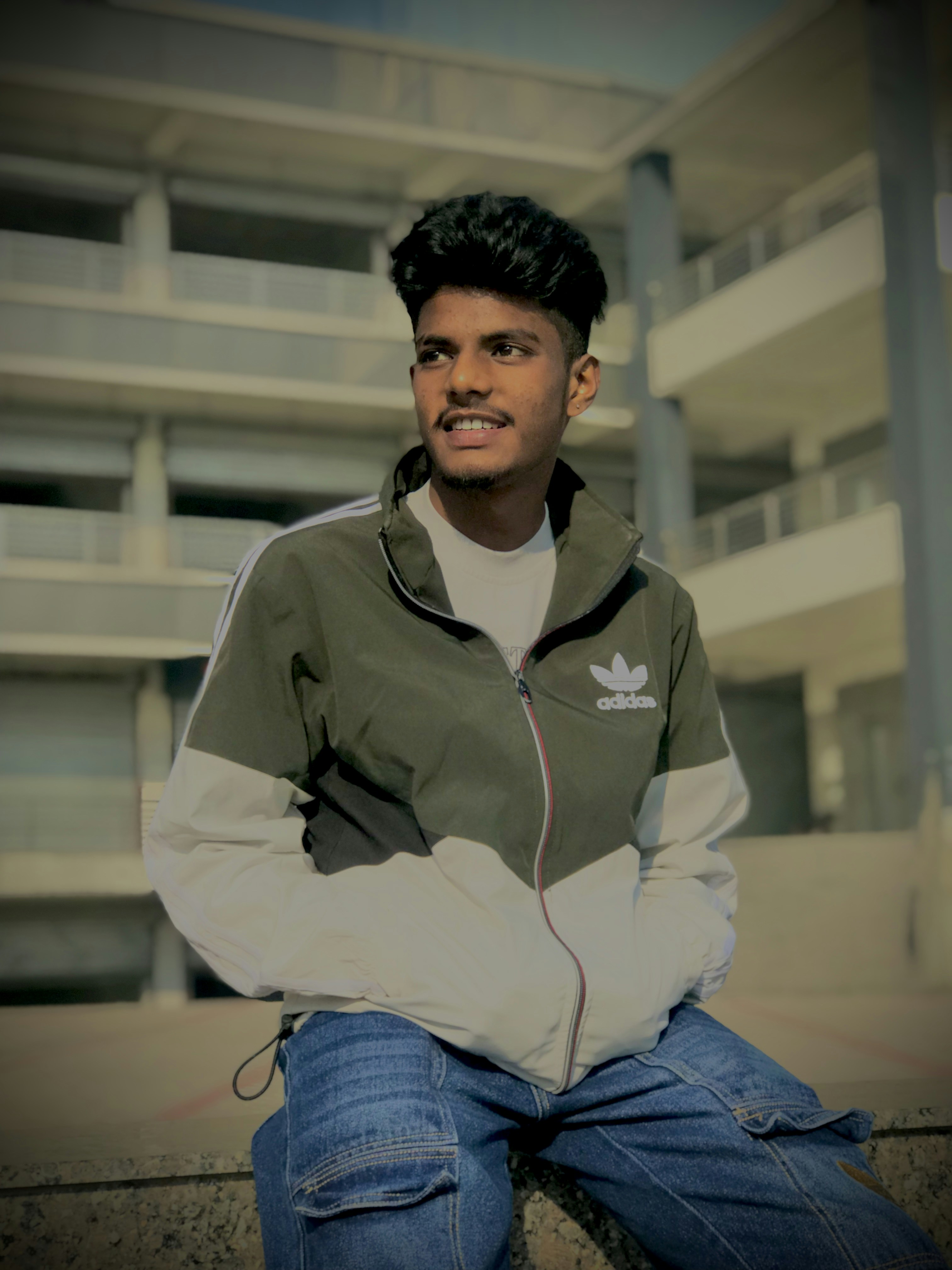 Young man smiling outdoors, casual style
