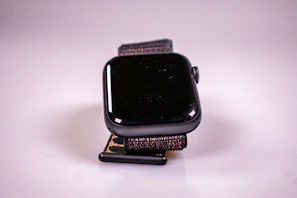 Close-up of a sleek smartwatch glowing on a wrist in natural light