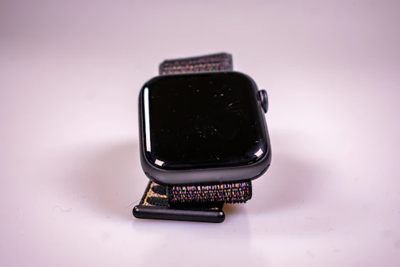 A close-up of a Meridian Wear smartwatch on a wrist, showcasing its minimalist design and vibrant display under natural light.