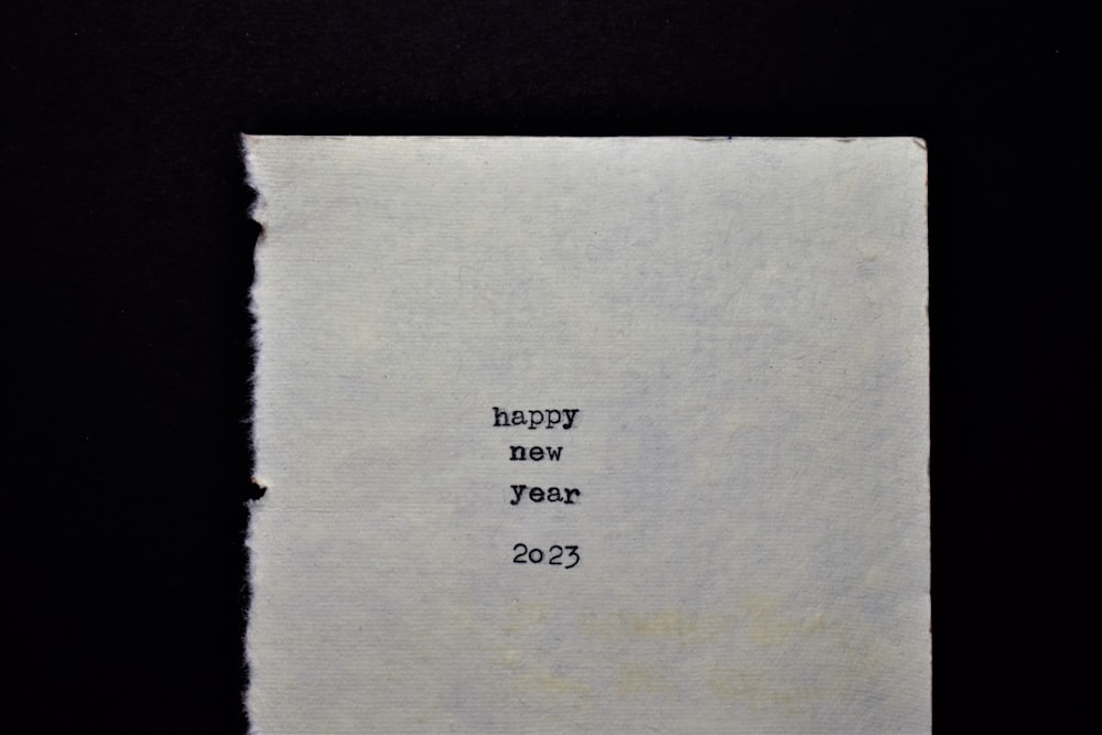 a piece of paper with the words happy new year written on it
