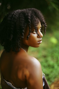 a woman with a brown dress is looking away from the camera