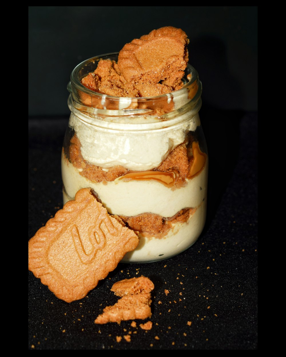 a jar filled with cookies and cream on top of a table
