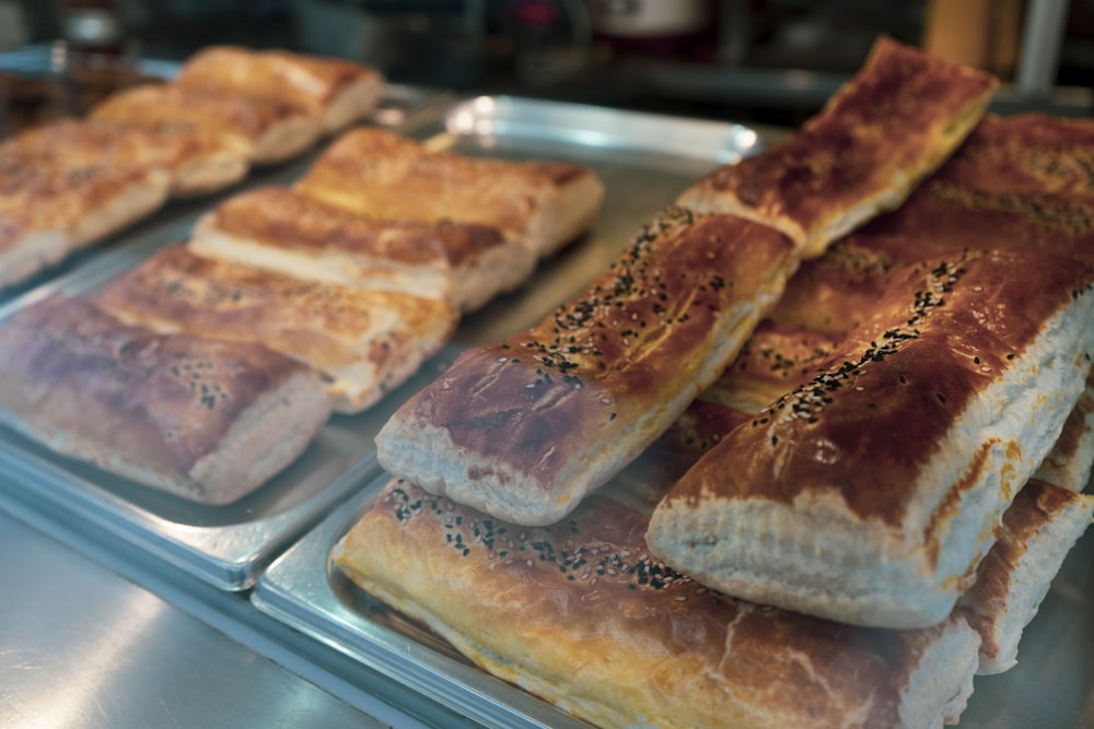 a bunch of different types of bread on a tray