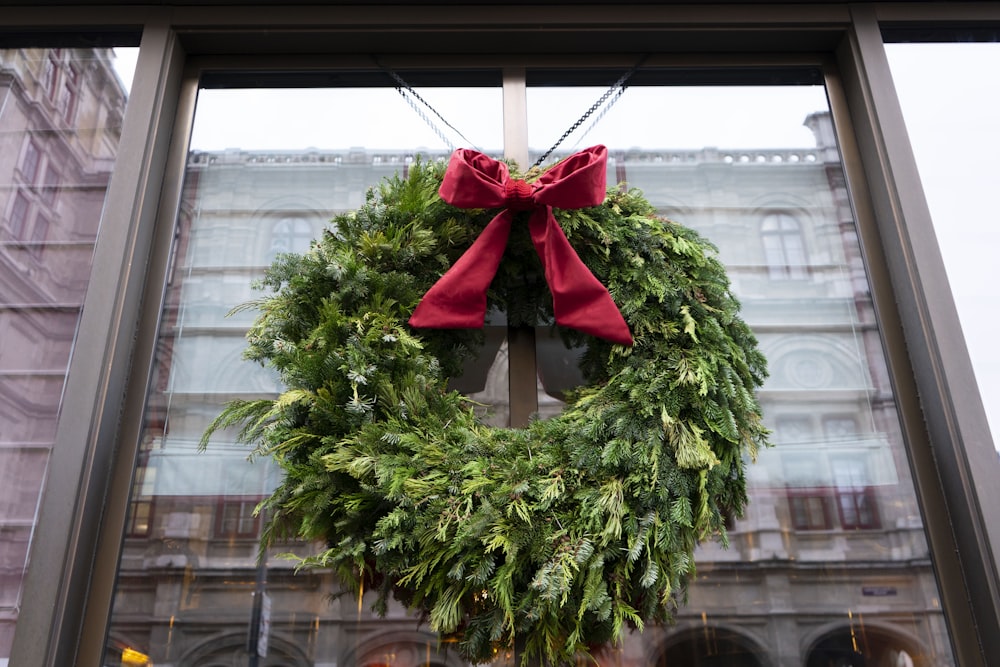 a christmas wreath hanging on the front of a building
