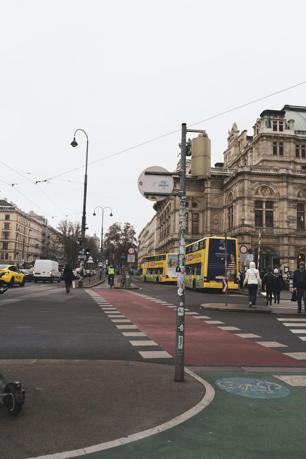 a city street filled with lots of traffic next to tall buildings