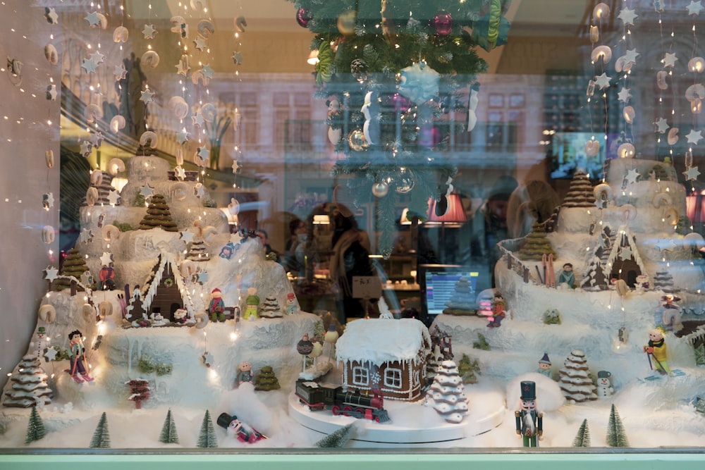 a window display of a christmas village in a store