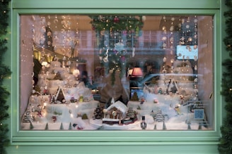 Window display featuring waterproof snowflake ornaments and twinkling lights creating a festive shop atmosphere.