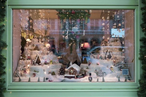 Window display featuring waterproof snowflake ornaments and twinkling lights creating a festive shop atmosphere.