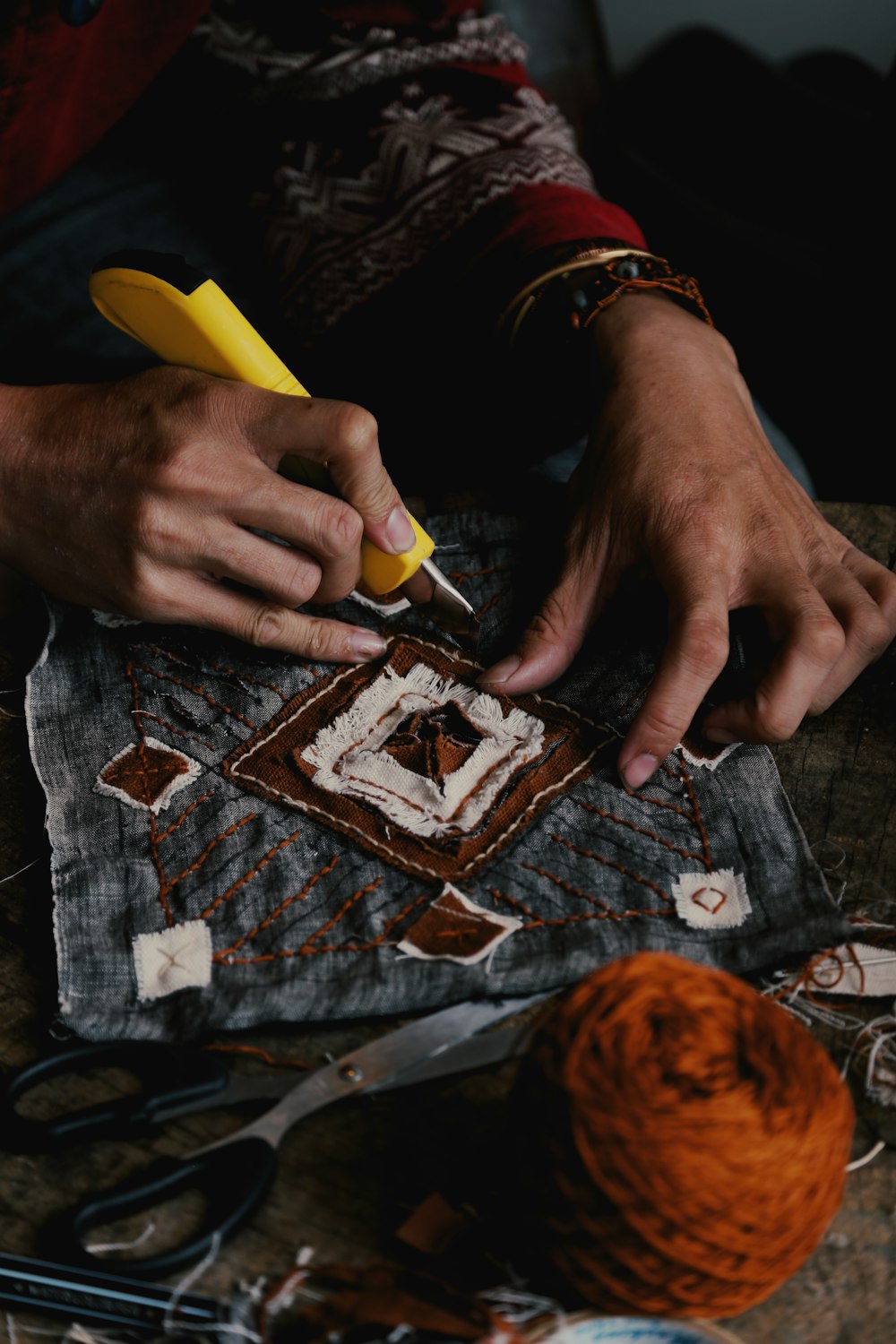 a person is working on a piece of cloth