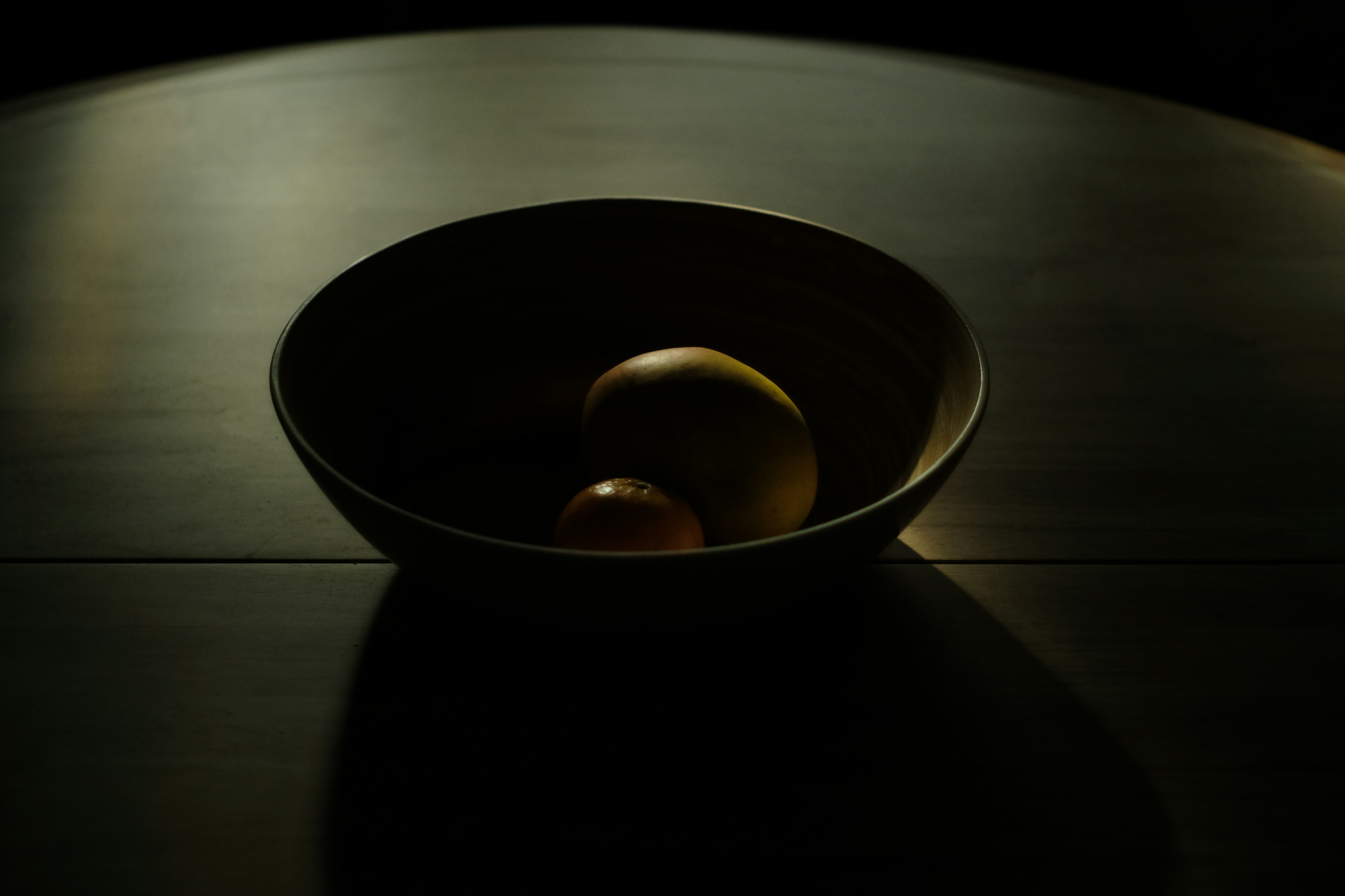 The late afternoon light filtering in onto a bowl of fruit