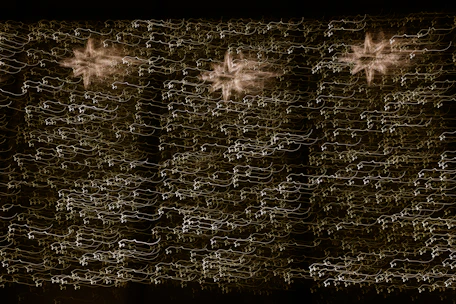 Radiant cosmic light beams merging with an intricate network of energy and life symbols.