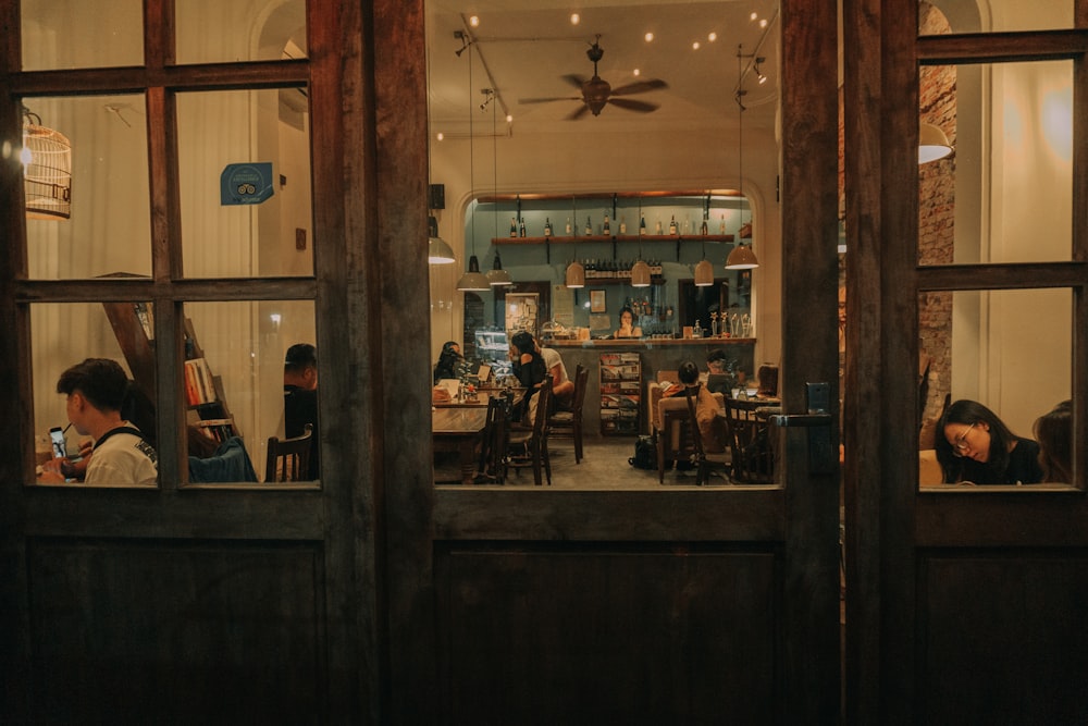 a group of people sitting at a table in a restaurant