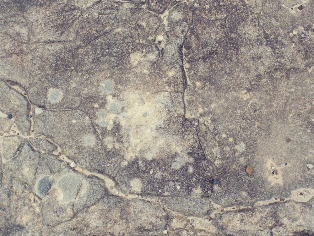 a close up of a rock surface with cracks