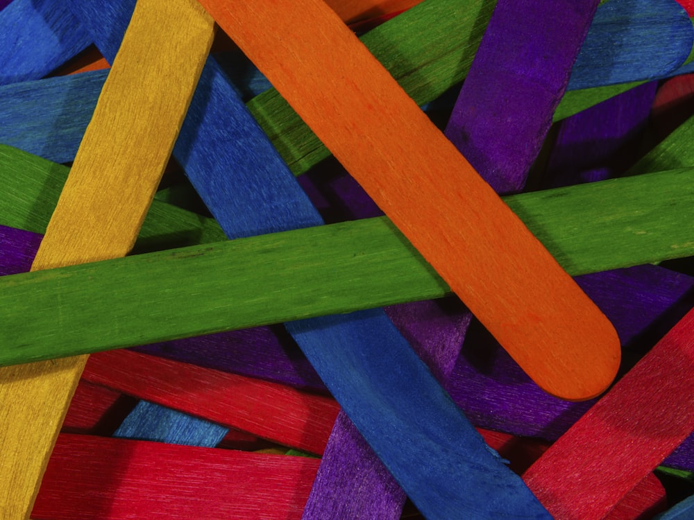 a close up of a pile of colored sticks