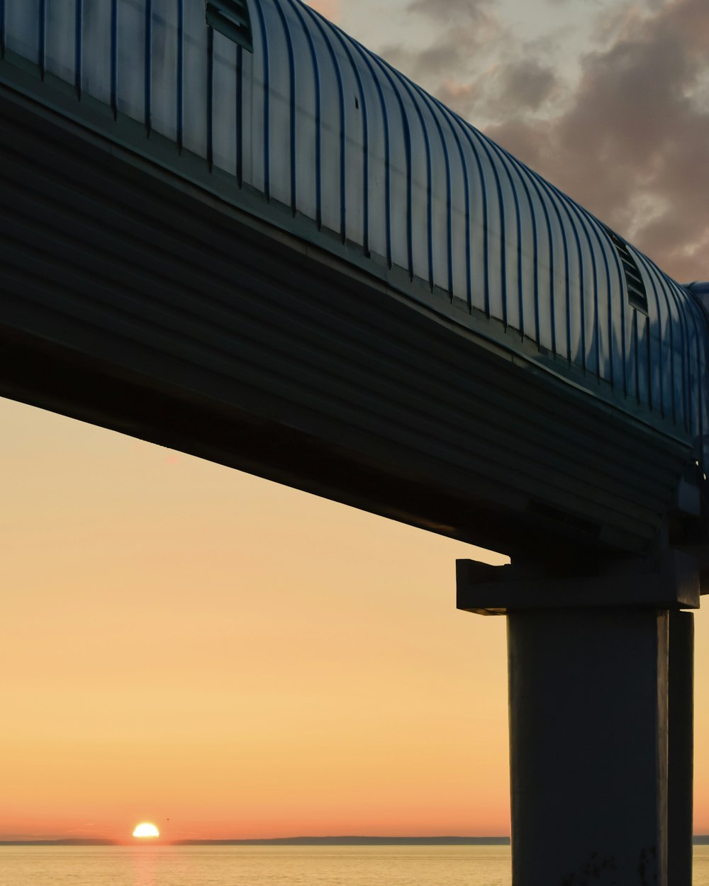 a train traveling over a bridge over a body of water