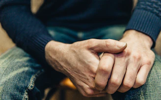 a close up of a person holding their hands together