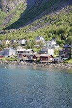 A scenic view of a coastal village with colorful houses and a clear blue sky.