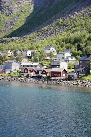 A scenic view of a coastal village with colorful houses and a clear blue sky.