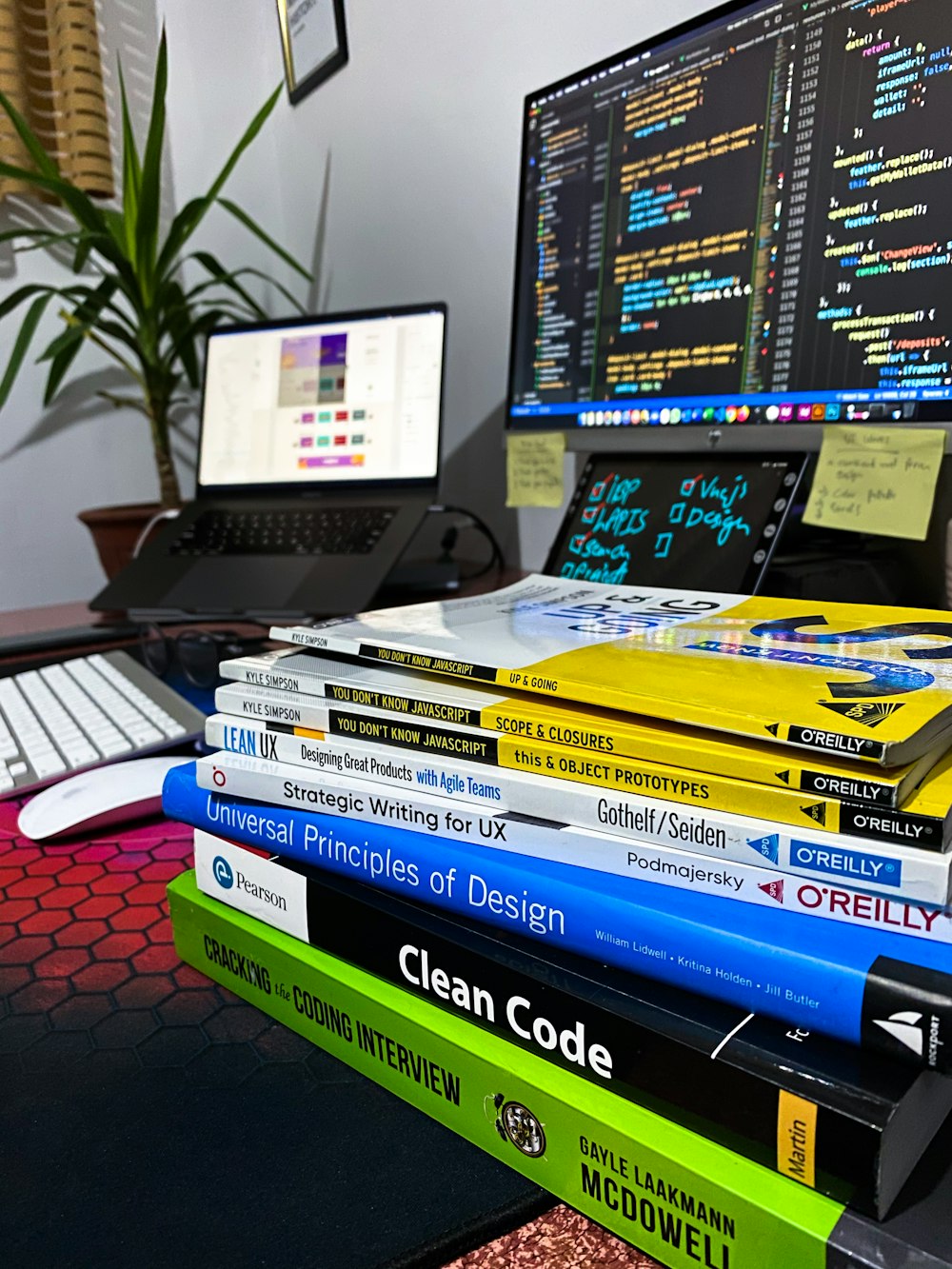 a stack of books sitting in front of a computer