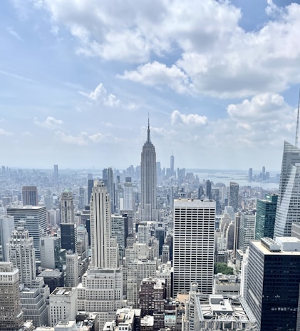 A panoramic view of a bustling city skyline featuring office buildings and retail centers managed by Cornerstone Global Enterprises.