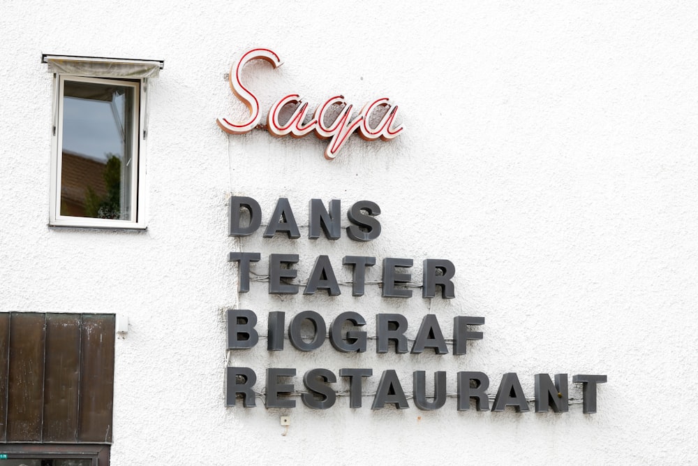 a restaurant sign on the side of a building