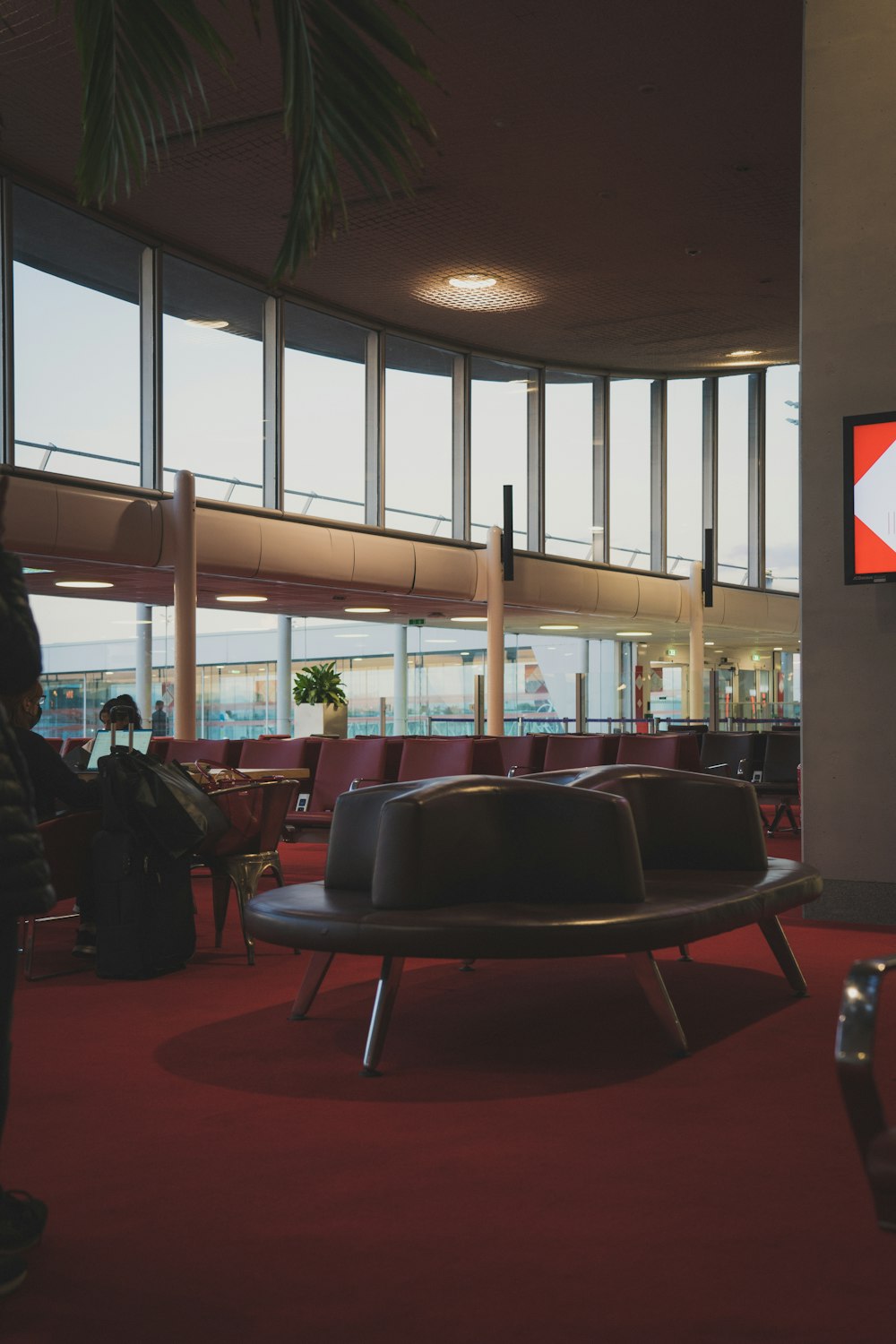 a large room with a red carpet and a large window