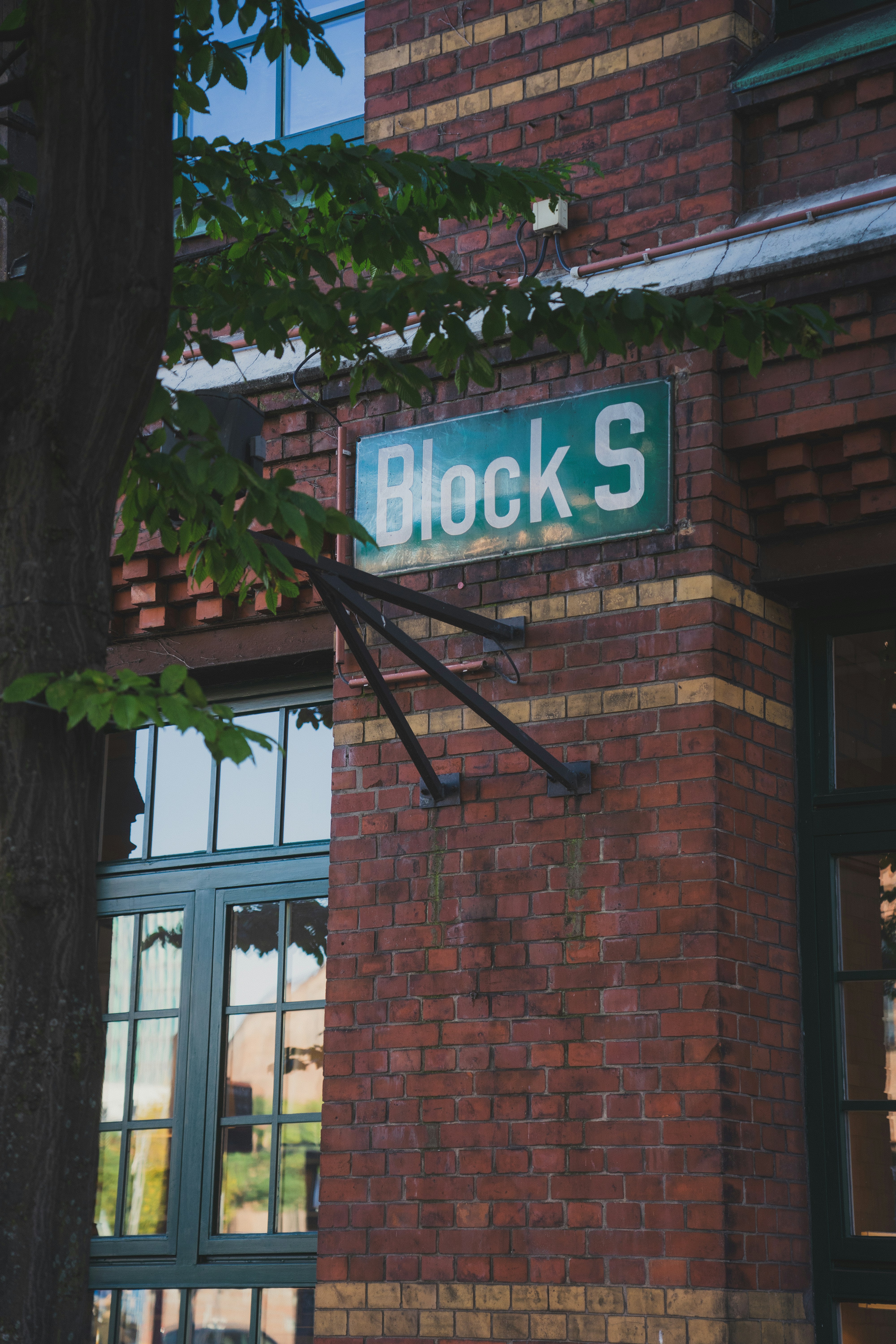 a brick building with a street sign on it