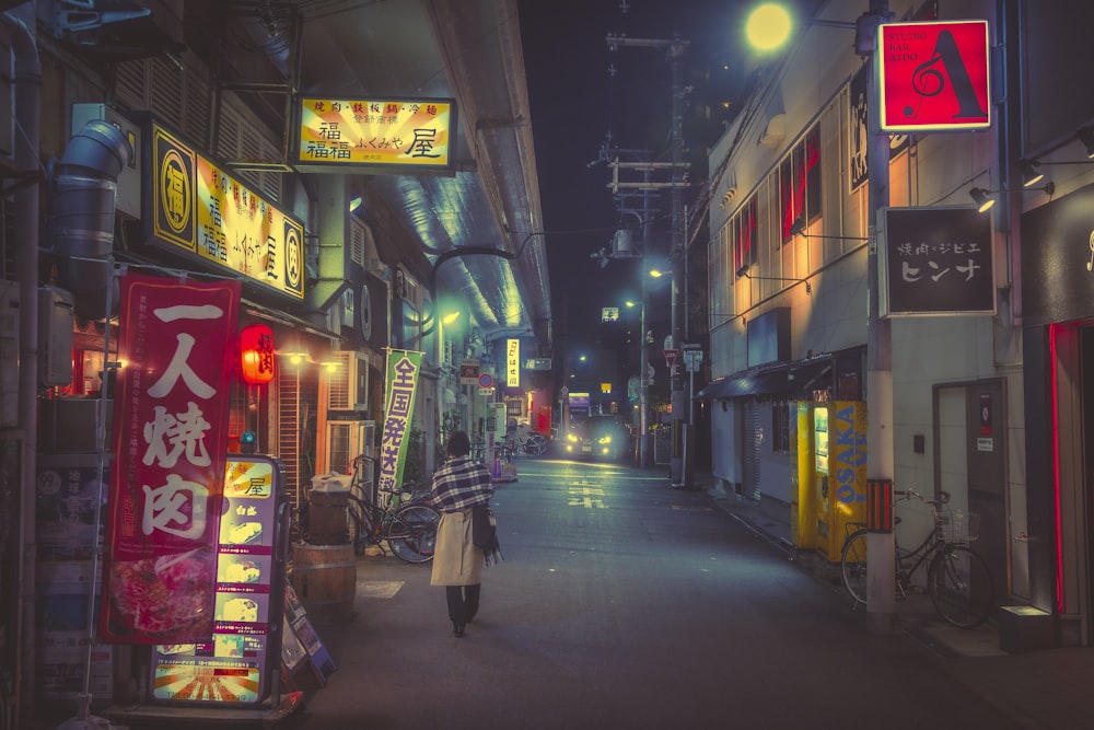 a woman walking down a street holding an umbrella