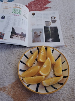 a plate of sliced oranges on a table