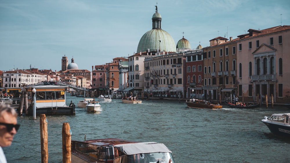 a canal with boats and buildings in the background