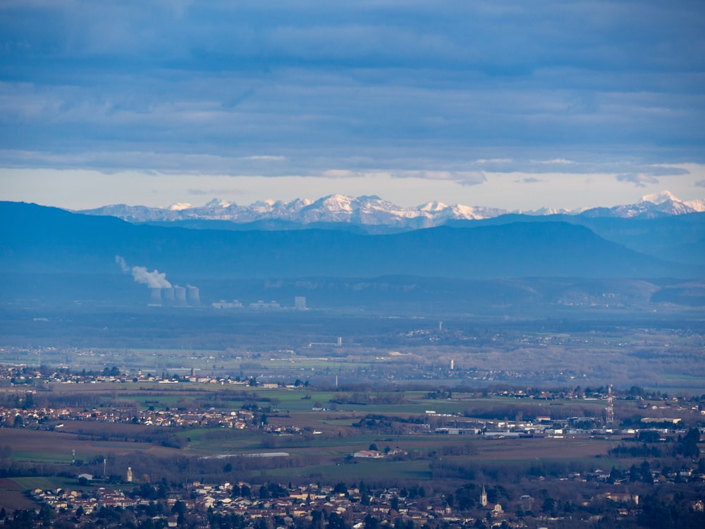 a view of a city with mountains in the background