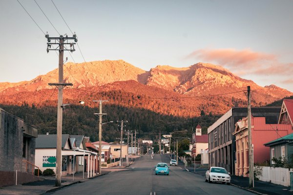 A car driving down a street with a mountain in the background — Tasmania, Australia