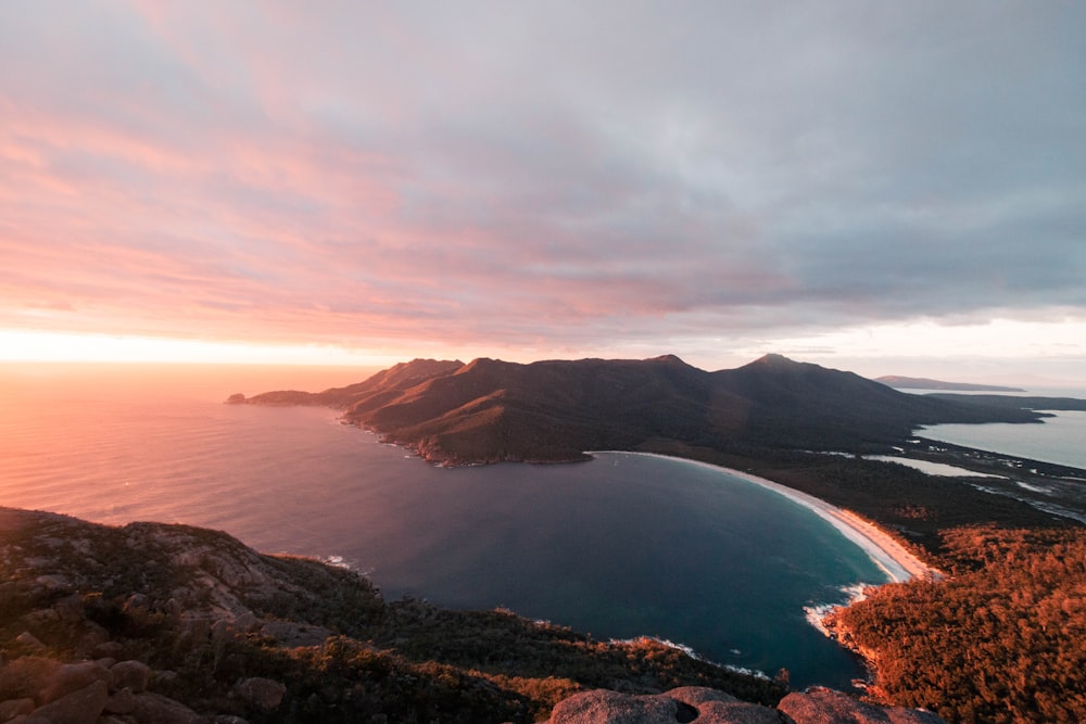 a view of the ocean and mountains from a hill