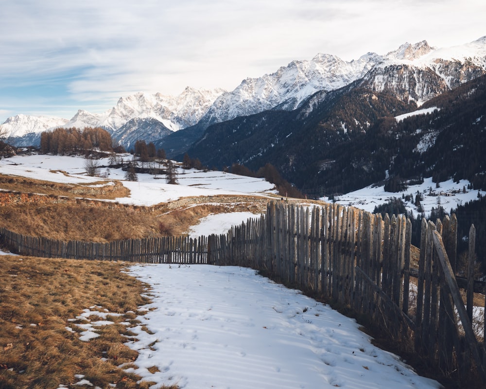 Una valla de madera en medio de un campo nevado