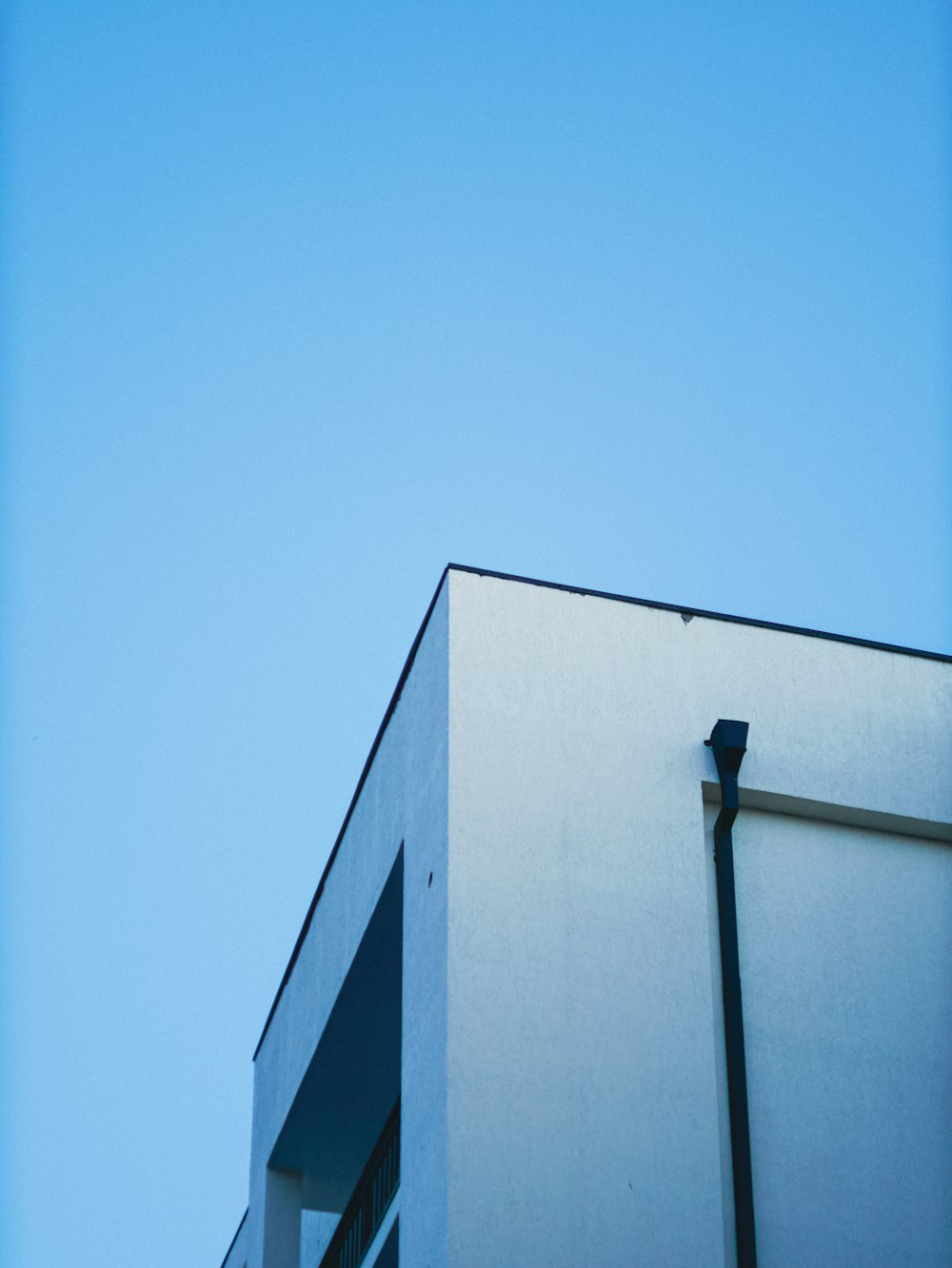 a tall white building with a street light next to it