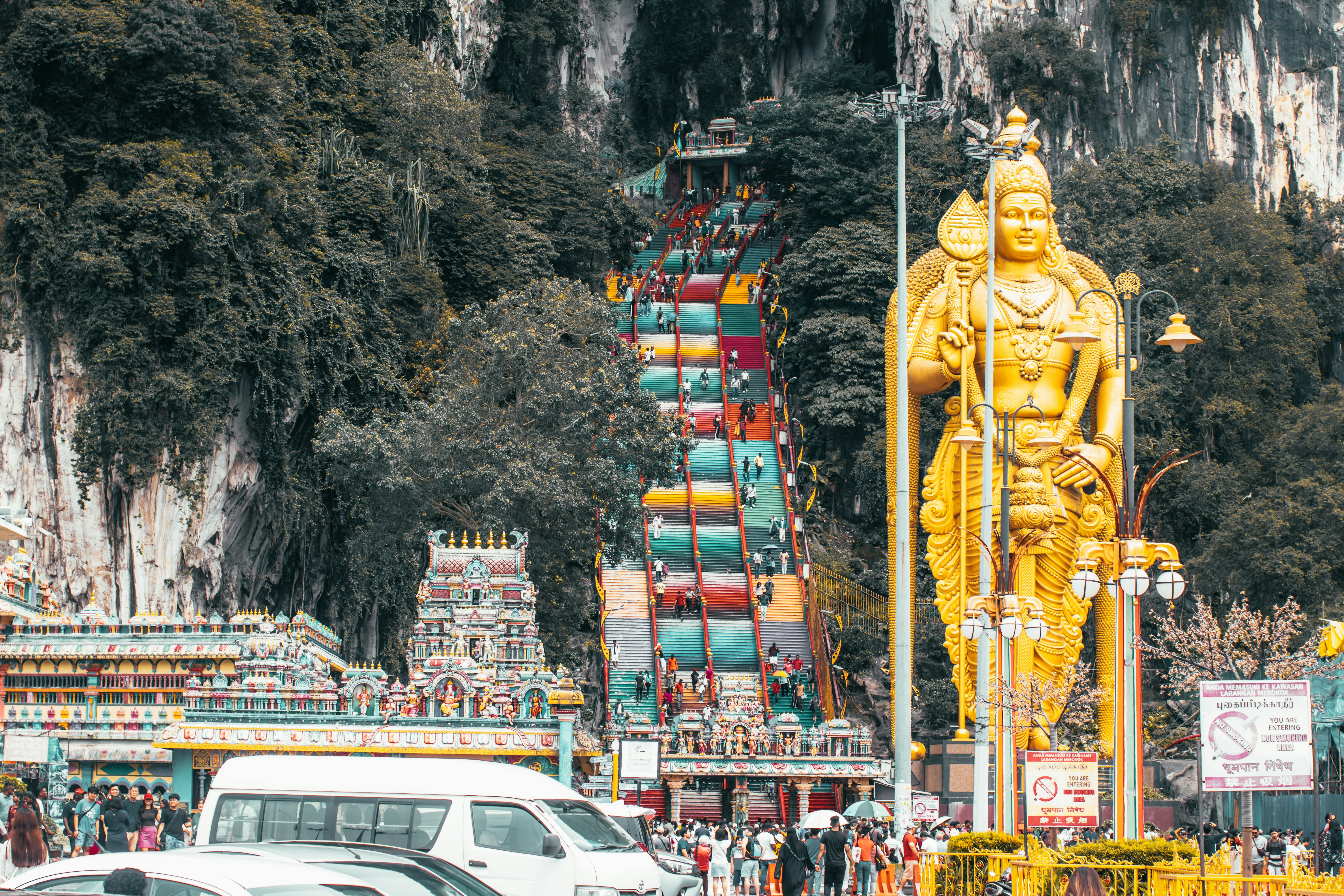 a large golden statue in the middle of a street