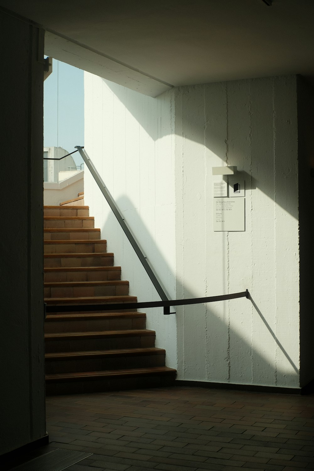a stair case in a building with a light coming through