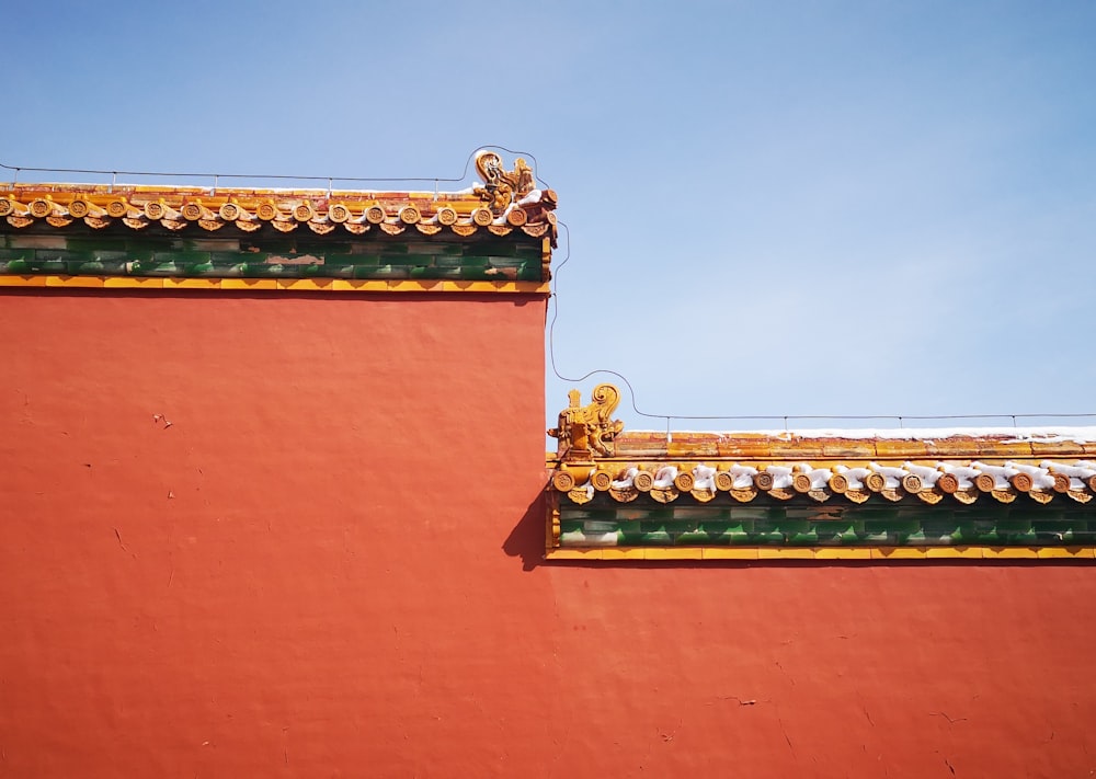 a red building with a yellow and green roof