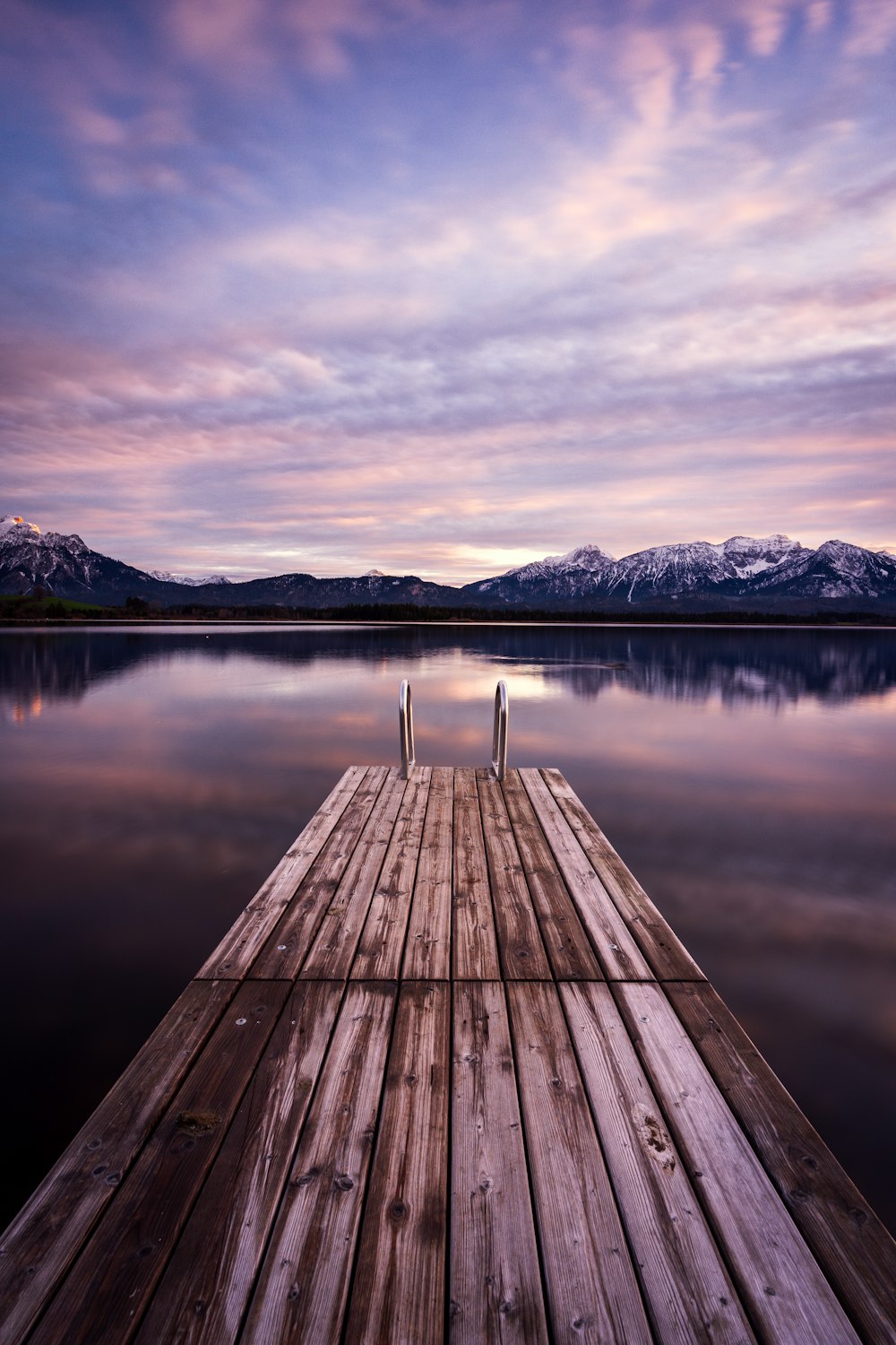 a wooden dock sitting on top of a lake