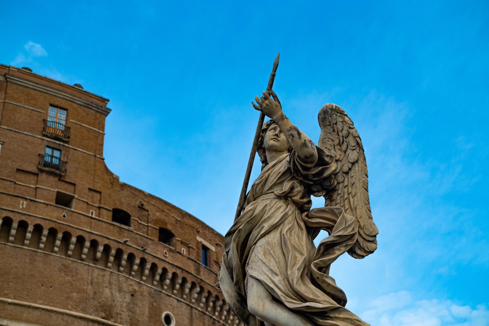 a statue of an angel on top of a building